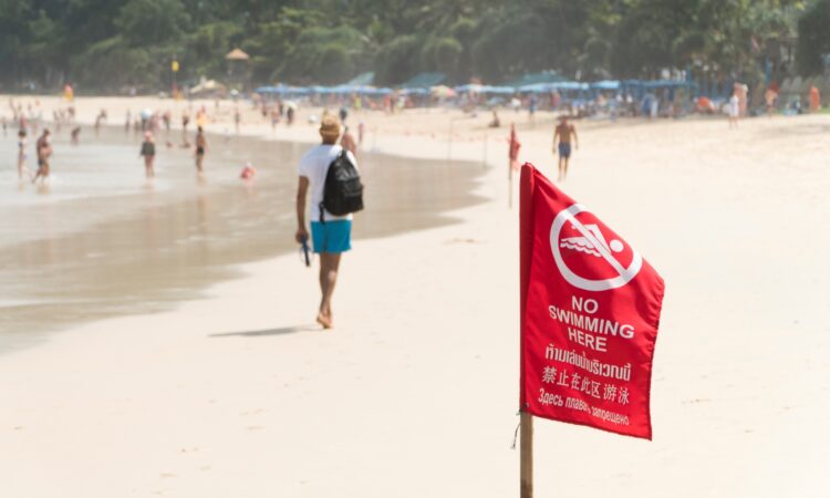 Bandera roja en la playa representa prohibido bañarse o nadar en esa área de la playa